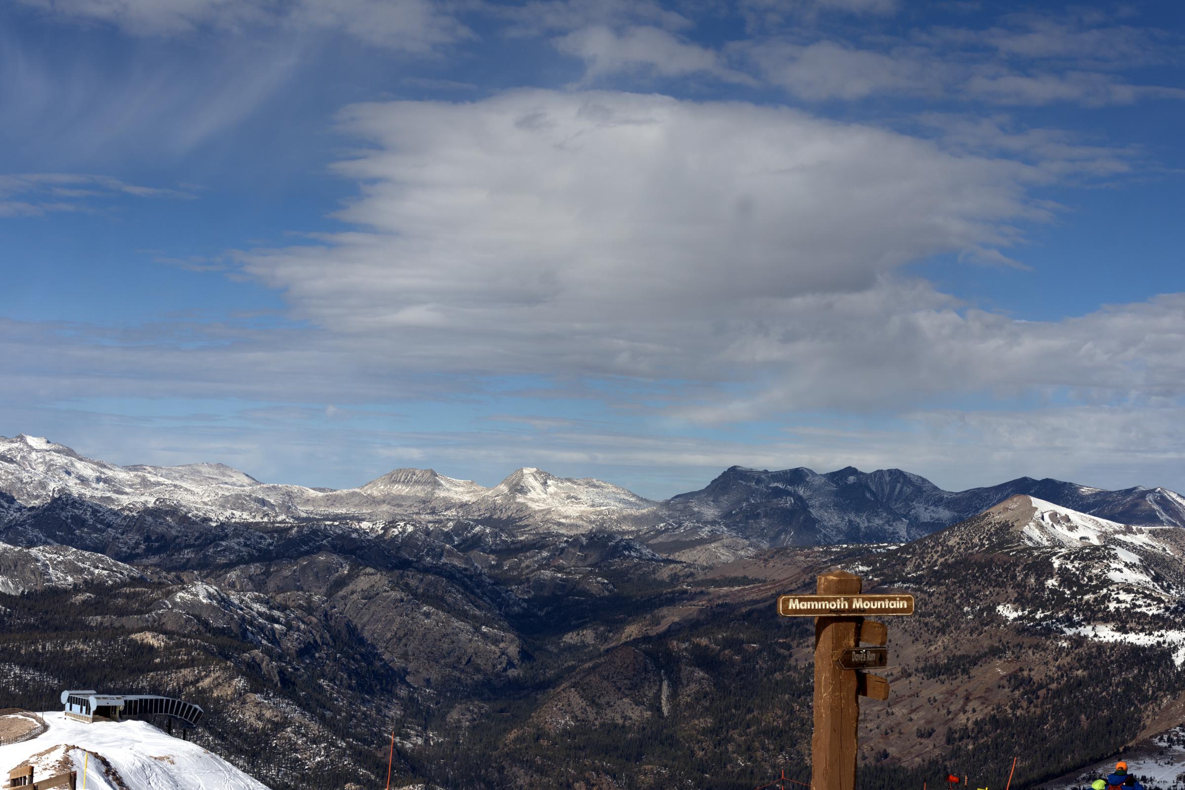 Color photograph of view of mountains and Mammoth Mountain sign, Mammoth Lakes, California — United States landscape.